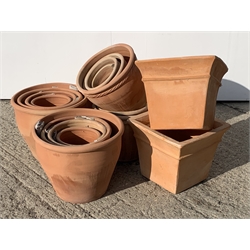 Twenty circular terracotta plant pots with rope twist rims and four square tapering terracotta plant pots, various sizes