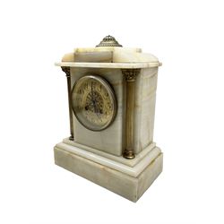 French - late 19th century Onyx cased mantle clock and conforming garnitures with an 8-day striking movment striking the hours and half hours on a coiled gong, rectangular formed case with recessed brass pillars and corinthian capitals, gilt metal dial with pierced decoration to the centre, arabic numerals and steel flur di Lis hands within a cast brass bezel. With pendulum. Garnitures H 28cm.