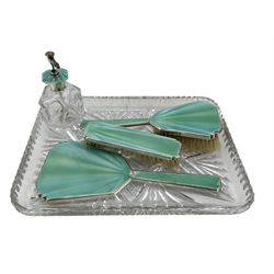 Silver mounted dressing dressing table set with blue and green enamel comprising scent sprayer, hair brush, hand mirror and clothes brush Birmingham 1936 Maker Henry Clifford Davis on a glass rectangular tray