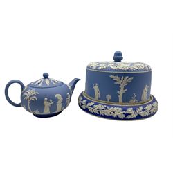 19th/ early 20th century blue Jasperware cheese dome decorated with Classical figures, borders of oak leaves, with an acorn finial, unmarked H21cm x D27cm together with a Wedgwood blue Jasperware teapot