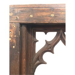Two oak prayer stands, decorated with floral carving and panels together with two oak communion rails, with gothic style carving and upholstered kneeler 