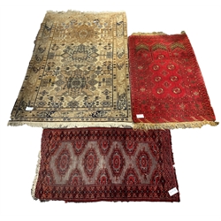 Afghan red prayer rug, with with central mihrab panel and gul motif, (77cm x 130cm) together with an eastern ground rug with hereti motif, on ivory field (120cm x 180cm) and a red tribal design hearth rug, (60cm x 116cm)
