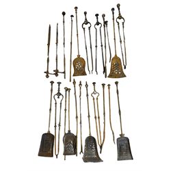 Large collection of 18th/19th century steel and brass fire irons, including some sets and a pair of implement stands (22)
