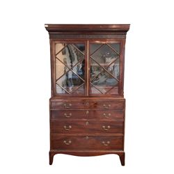 19th century mahogany bookcase on chest, the projecting dentil cornice and carved frieze over two glazed doors of astragal design, opening to reveal one fixed shelf and two short drawers, leading into four graduated drawers W110cm, H198cm D55cm 