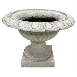 White painted cast iron bowl shaped urn, egg and dart moulded rim and gadrooned underbelly, on moulded foot and square base