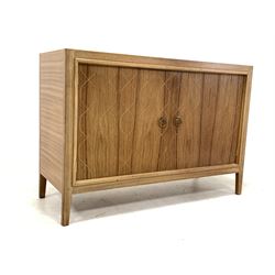 Gordon Russell - Mid 20th century teak 'Double Helix' sideboard, the front with double doors opening to reveal a shaped shelf and drawer, raised on square tapered supports, bearing 'Russell of Broadway' label to reverse W122cm, H84cm, D46cm