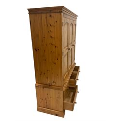 Pine wardrobe, the projecting cornice over two doors, opening to reveal interior fitted for hanging over three short and two long drawers, raised on bracket supports W157cm, H211cm, D63cm 