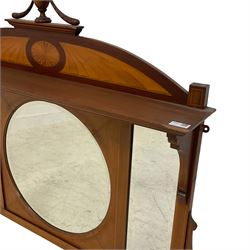 Edwardian inlaid mahogany overmantel mirror, the arched pediment with satinwood fan inlay mounted by turned finial, projecting moulded lintel over circular and rectangular bevelled mirror plates, shaped side brackets