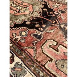 Vintage Persian red ground runner rug, geometric pole medallion enclosed by border decorated with geometric foliate 326cm x 107cm