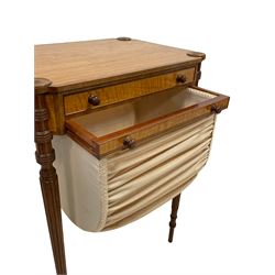Sheraton Revival - Edwardian satinwood work table, the canted rectangular top with support roundel mounts and banding, shallow single drawer above sliding upholstered storage basket, on collar turned and reeded tapering supports