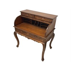 French design hardwood writing desk, the top fitted with two drawers with shell and foliate carved facias over the tambour roll top, enclosing fitted interior, the ornate base with two drawers over a shaped and carved apron, raised on cabriole supports with acanthus leaf decoration