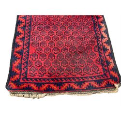 Persian Baluchi crimson ground runner rug, the field with all-over dark indigo geometric patterns, enclosed by borders of Vitruvian waves and repeating geometric shapes