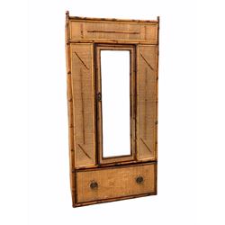 Late Victorian aesthetic period bamboo and rattan single wardrobe, the mirrored door enclosing interior fitted for hanging, single deep drawer to base W89cm, H182cm, D42cm