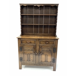 18th century style medium oak dresser, with two height plate rack over two drawers and two lunette carved panelled cupboards enclosing shelf, raised on block supports, W103cm, H172cm, D44cm