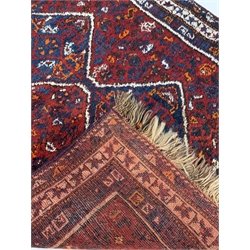 Eastern rug, with pole medallion on red field, enclosed by multi line border, 200cm x 122cm