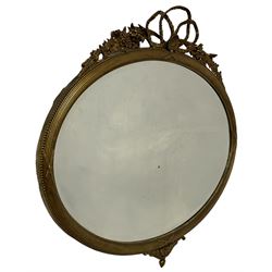Gilt framed oval wall mirror with floral and foliate decoration, surmounted with a shell pediment 