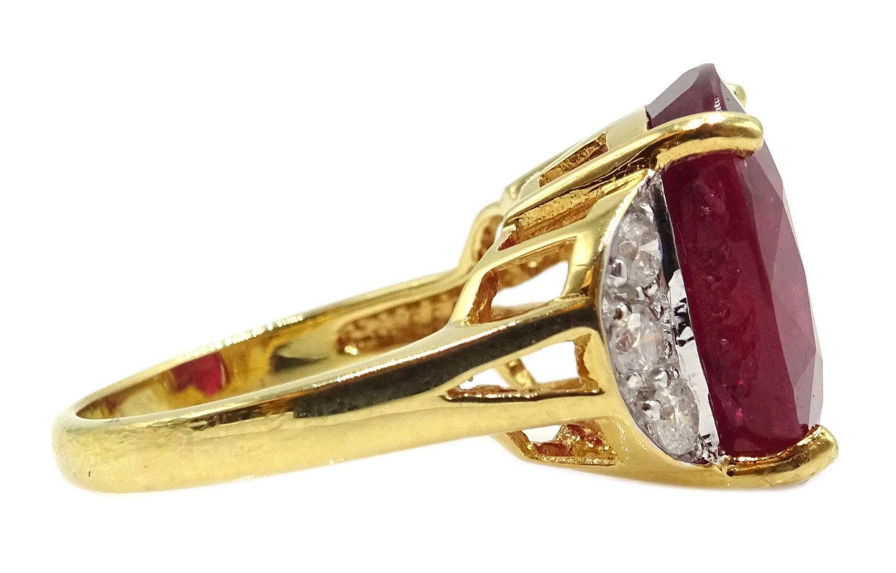 18ct gold oval ruby ring, with three diamonds set each side, hallmarked