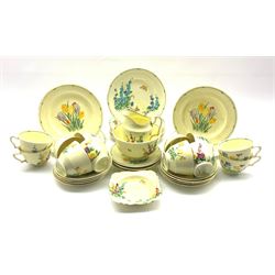 Art Deco Crown Staffordshire 'Pan' Design tea service for twelve, printed and painted in bright enamels with assorted spring and summer flowers, Crocus, Pansies, Hollyhocks, Buttercups, Carnations, etc, comprising teacups, saucers, side plates, milk jug, small dish, slop bowl and cake plate 