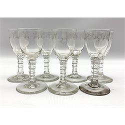 Seven 19th century cordial glasses decorated with trailing garlands on facet cut stems H13cm