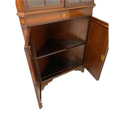 Edwardian Sheraton revival corner display cabinet, the broken arch pediment and dentil cornice over two astragal design glazed doors over two cupboard doors, raised on bracket supports 