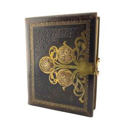 Victorian stamped leather photograph album with cut brass mounts and clasp containing portrait photographs