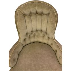 Victorian nursing chair, upholstered in green buttoned back fabric, raised on turned supports and terminating in brass castors 