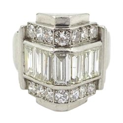 Platinum baguette and round brilliant cut diamond ring, the central row with seven channel set baguette cut diamonds, each side with seven round brilliant cut diamonds, in a stepped triangular design setting