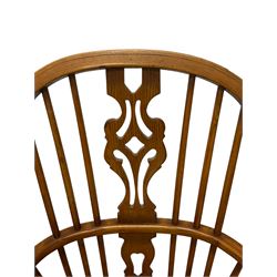 Elm Windsor chair, high back with pierced splat and spindle supports over shaped saddle seat, raised on cabriole front supports united by crinoline stretcher
