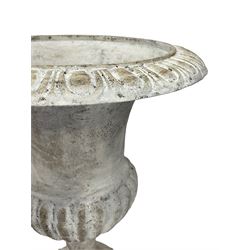 Pair of cast iron Campana shaped urns, egg and dart moulded rim over bulbous body with gadrooned underbelly, on tapered footed base and square plinth, white painted finish 