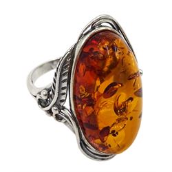 Silver oval Baltic amber ring, with leaf design gallery, stamped 925 