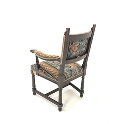 Waring & Gillow - Late 19th/Early 20th century carved oak open armchair, with needlework upholstered seat and back, raised on turned and block supports united by moulded stretchers, W62cm