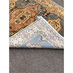 Persian design ground rug, with floral decoration on a teal field, enclosed by border (195cm x 120cm) together with a similar ground rug, (195cm x 122cm)