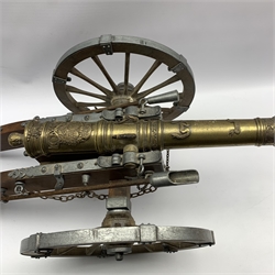 Model of a Louis XIV canon, metal mounted wood carriage with rotating wheels and embossed brass barrel, L77cm