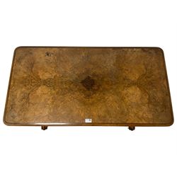 Victorian figured walnut stretcher card table table, rectangular swivel and fold-over top with moulded edge and inset baize lining, raised on turned vasiform end supports with foliate carved decoration terminating in splayed and scrolled feet with ceramic castors