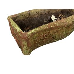 Pair of cast stone garden planters, rectangular form with shaped front, decorated with putti and trailing leafy branches