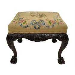 Georgian design cabriole leg stool, rectangular form upholstered in floral needlework cover, the shaped rails carved with shell and trailing foliate, acanthus carved cabriole supports with ball and claw feet