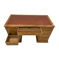 20th century oak writing desk, the leather inset top and three frieze drawers over six graduated drawers, raised on a plinth base