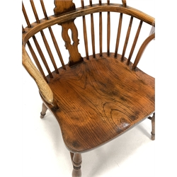 20th century elm Windsor chair, hoop and spindle back with carved splat centred by roundel, shaped arm terminals, saddle seat, raised on turned supports united by crinoline stretcher