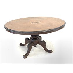 Victorian inlaid walnut oval tilt top loo table, raised on pedestal base with four leaf carved and splayed supports W132cm