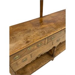 20th century elm dresser, the projecting cornice and two height plate rack over base, fitted with three drawers and three faux drawers and pot board base, raised on turned and squared supports 