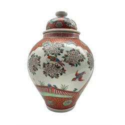 Japanese vase and cover decorated with panels of exotic birds in a fenced garden setting, on red and gilt scroll ground, marked Zoshuntei Sanpo Zu, H30cm