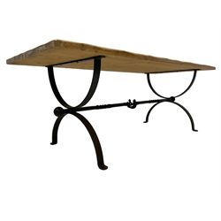 Stripped pine dining table, rectangular top raised on wrought metal curved X-frame base, united by spiral turned stretcher