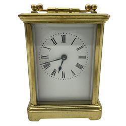 A late 19th century French Corniche carriage clock with four bevelled glass panels and a rectangular panel to the top, eight-day spring driven timepiece movement with a replacement lever escapement, balance wheel and timing screws, with a white enamel dial, Roman numerals, minute markers and steel spade hands. With Key.