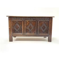 18th Century style oak coffer with moulded top lifting to revel plain interior, 3 panelled front carved with lozenges and raised on stile supports. 