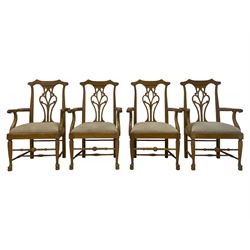 Set eight light oak Chippendale design carver dining chairs, shaped cresting rail with pierced and scrolled splat backs, upholstered seats with scrolling arm terminal, on cabriole supports with pad feet 
