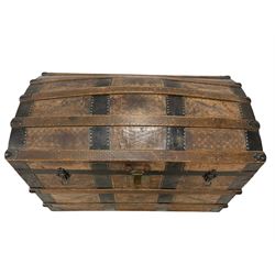 Victorian leather bound travelling trunk, hinged dome top, the outside decorated with etched geometric designs and wrought iron strapping with studwork borders