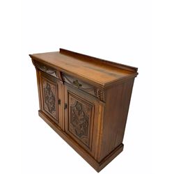 Edwardian walnut sideboard, fitted with two drawers over two floral carved panelled doors, raised on a skirted base 