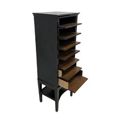 Ebonised sheet music cabinet, the projecting top over seven fall front drawers with Wellington style lock and one under-tier raised on squared tapering supports 