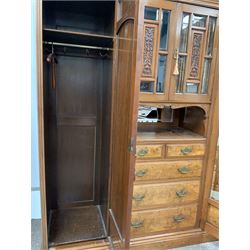 Late Victorian walnut wardrobe, broken arch pediment and dentil cornice over bevel glazed millinery cupboard with floral carved panels, bevelled mirror, open shelf and two short and three long drawers, flanked by two bevel glazed mirror doors, each enclosing interior fitted with shelf and for hanging, raised on a plinth base with recessed castors, W195cm, H212cm, D61cm