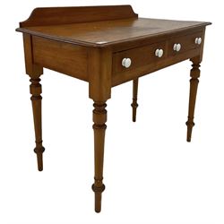 Victorian style pine side table, the raised back over two drawers, raised on turned supports 